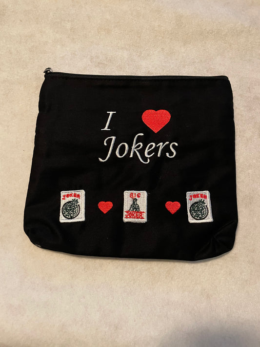 Black mahjong-themed zippered pouch featuring embroidered "I Love Jokers" lettering with a red heart, decorative joker mahjong tiles, and small red hearts.