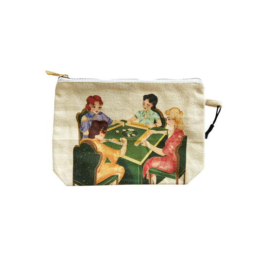 Natural canvas zipper pouch featuring a colorful vintage-style illustration of four women playing mahjong around a green table. Features a gold zipper and a small side loop for carrying mahjong accessories and personal essentials.