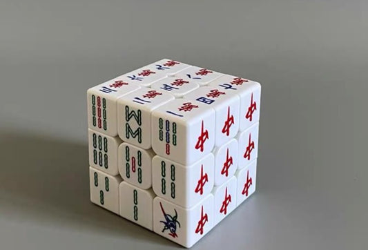 Mahjong-themed 3x3 puzzle cube featuring white mahjong tiles with traditional Chinese characters and bamboo symbols in red, green, blue, and black.