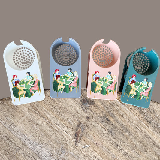 Four colorful mahjong tile holders in white, blue, pink, and teal, featuring a vintage illustration of four women playing mahjong. Each holder has a circular perforated design with a smiley face.