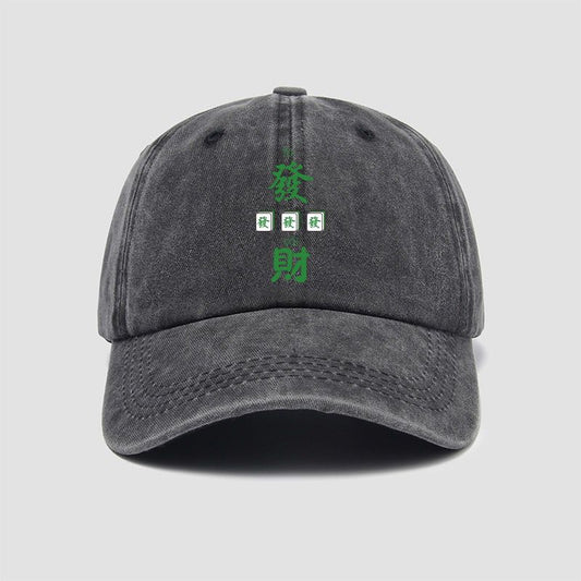 Vintage washed charcoal gray mahjong-themed baseball cap featuring green Chinese characters symbolizing prosperity and wealth, with three small Green Dragon mahjong tile illustrations.